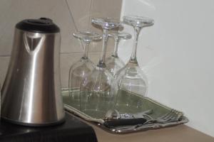 a group of wine glasses in a tray on a counter at B&b Sant'Agata in Sant'Agata de' Goti