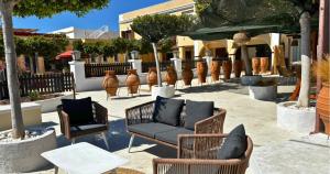 a group of chairs and tables in a courtyard at Palatino Seafront Residence in Alinda