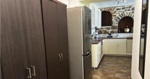 a kitchen with a stainless steel refrigerator at Palatino Seafront Residence in Alinda +23 photos