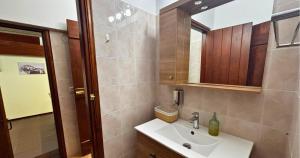 a bathroom with a sink and a mirror at Palatino Seafront Residence in Alinda