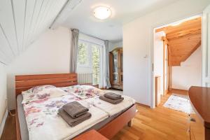 a bedroom with a bed with towels on it at Sanjska Hiša Vojsko in Idrija +25 photos
