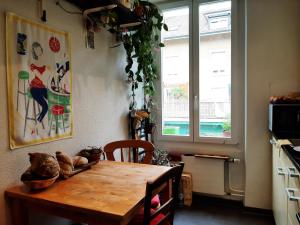 a kitchen with a wooden table and a window at Bern room near Main Station in Bern