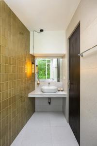 a bathroom with a sink and a mirror at The Plunge by Duo Escapes in Gonahena +14 photos