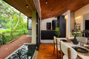 a kitchen and dining room with a table and chairs at The Plunge by Duo Escapes in Gonahena