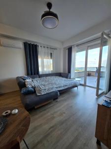 a living room with a bed and a couch at apartman Dalas Star Dojran in Star Dojran