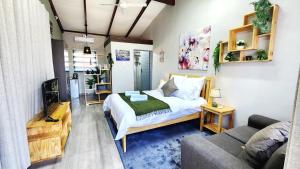 a small bedroom with a bed and a couch at Blairgowrie Skyline in Johannesburg
