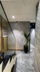 a staircase in a building with a potted plant at X-ones place command in Meran +1 photo
