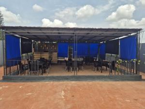 a pavilion with a table and chairs in it at D-vine Apartments & Hotels in Benin City