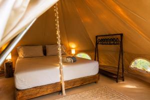 a bedroom with a bed in a tent at Shamalay - Nomad Experience in Bacalar