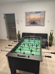 a large pool table with a green in a room at Siggis und Anyas Ferienwohnung mit Sauna und XXXL-Dusche in Sasbachwalden