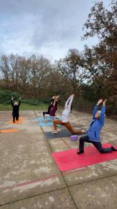 a group of people doing yoga in a parking lot at Apartamentos Casasturga in Collado