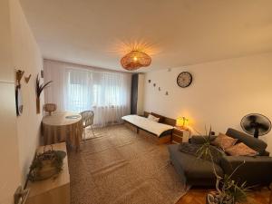 a living room with a couch and a table at Sloth Room in Warsaw