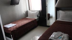a hotel room with two beds and a mirror at Lux hotel in Tbilisi City +5 photos