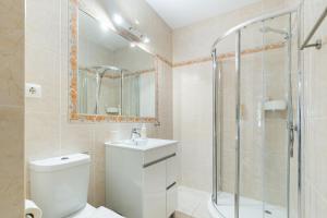a bathroom with a shower and a toilet and a sink at New Horizon Algarve in Almancil +9 photos