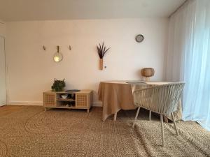 a dining room with a table and a chair at Sloth Room in Warsaw