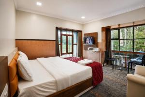 a hotel room with a bed and a window at Lake Residency Ooty in Ooty +51 photos
