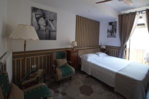 a hotel room with a bed and a chair at B&B Sant'Agata Appartamento in Sant'Agata de' Goti