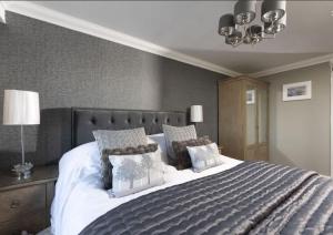 a bedroom with a large bed with pillows at Crystal View by the Sea in Carbis Bay +23 photos