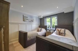 a bedroom with two beds and a window at Crystal View by the Sea in Carbis Bay