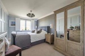 a bedroom with a bed and a dresser and a window at Crystal View by the Sea in Carbis Bay
