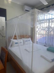 a bedroom with a bed covered in plastic at Angels Lodge in Dar es Salaam