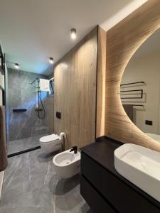 a bathroom with two toilets and a sink and a shower at Akacia Chalet in Moieciu de Jos +14 photos