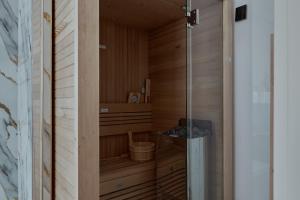 a wooden sauna with a bucket in it at Living am Carlsplatz Apartment in Düsseldorf +110 photos