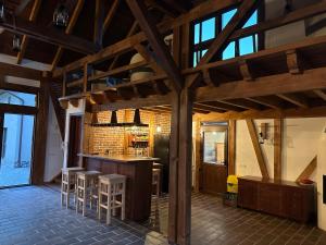 a kitchen with a bar and stools in a room at Ohaba 140-141 By Holztreppe in Ohaba