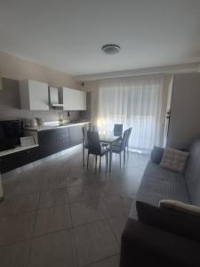a kitchen and a living room with a table and chairs at Le Dune per 4 in Silvi Marina +30 photos
