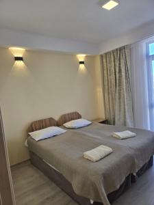 a bedroom with a bed with two towels on it at Baytur-Yilla09 in Bosteri +17 photos