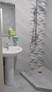 a bathroom with a sink and a shower at Hotel G&G in Tsaghveri
