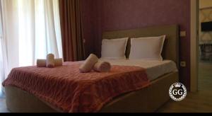 a bedroom with a bed with two pillows at Hotel G&G in Tsaghveri