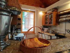 a kitchen with a basket of bread on a counter at Jumpravmuižas pirtiņa ar kublu in Mežotne +39 photos