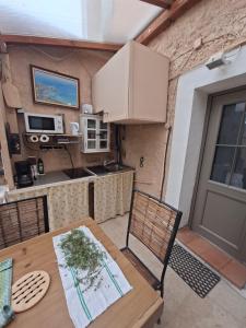 a kitchen with a wooden table and a table and chairs at Merozzini in Moltifao