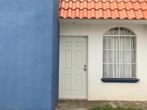 a blue and white house with a white door and a window at Ruah Home in Guadalupe