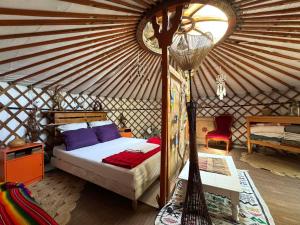 a bedroom with a bed in a yurt at La Yourte climatisée du Jardin Caché in Marmande