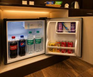 an open refrigerator with bottles of soda and drinks at Hotel Kings Inn, Karol Bagh, New Delhi in New Delhi +36 photos