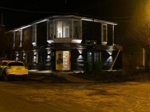 a house with a yellow car parked in front of it at El Refugio in Puerto Natales