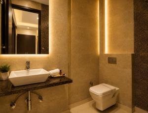 a bathroom with a sink and a toilet and a mirror at Hotel Kings Inn, Karol Bagh, New Delhi in New Delhi