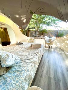 a bedroom with a bed in a tent at Fuente del Lobo Glamping & Bungalows - Adults Only in Pinos Genil +50 photos