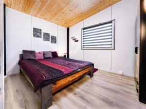 a bedroom with a large bed in a room at Dovolenkový dom in Mojš