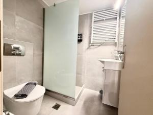 a bathroom with a toilet and a sink at Rania's Seaside Nest- Steps from the Beach in Kiaton +3 photos