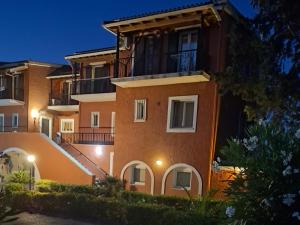 an apartment building at night with its lights on at SV Apartment with sea view in Gouvia