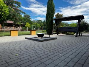 a park with a bench and a fire hydrant at Emma apartman in Číčov +11 photos