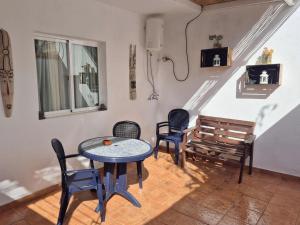 a room with a table and chairs and a bench at Luz del Mar in Órzola +8 photos