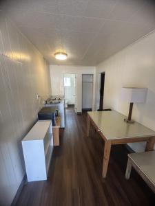 an empty room with a desk and a table at Union Avenue Motel in Portland +19 photos