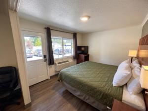 a hotel room with a bed and a window at Union Avenue Motel in Portland