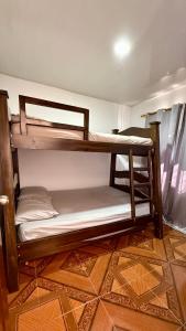 a couple of bunk beds in a room at Casa comoda con aire y garaje en La Union Valle in Lemos +15 photos