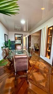 a dining room with a glass table and chairs at Casa comoda con aire y garaje en La Union Valle in Lemos