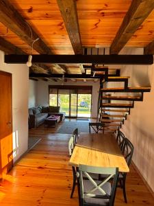 a dining room with a table and a spiral staircase at Gabriels7 in Korita